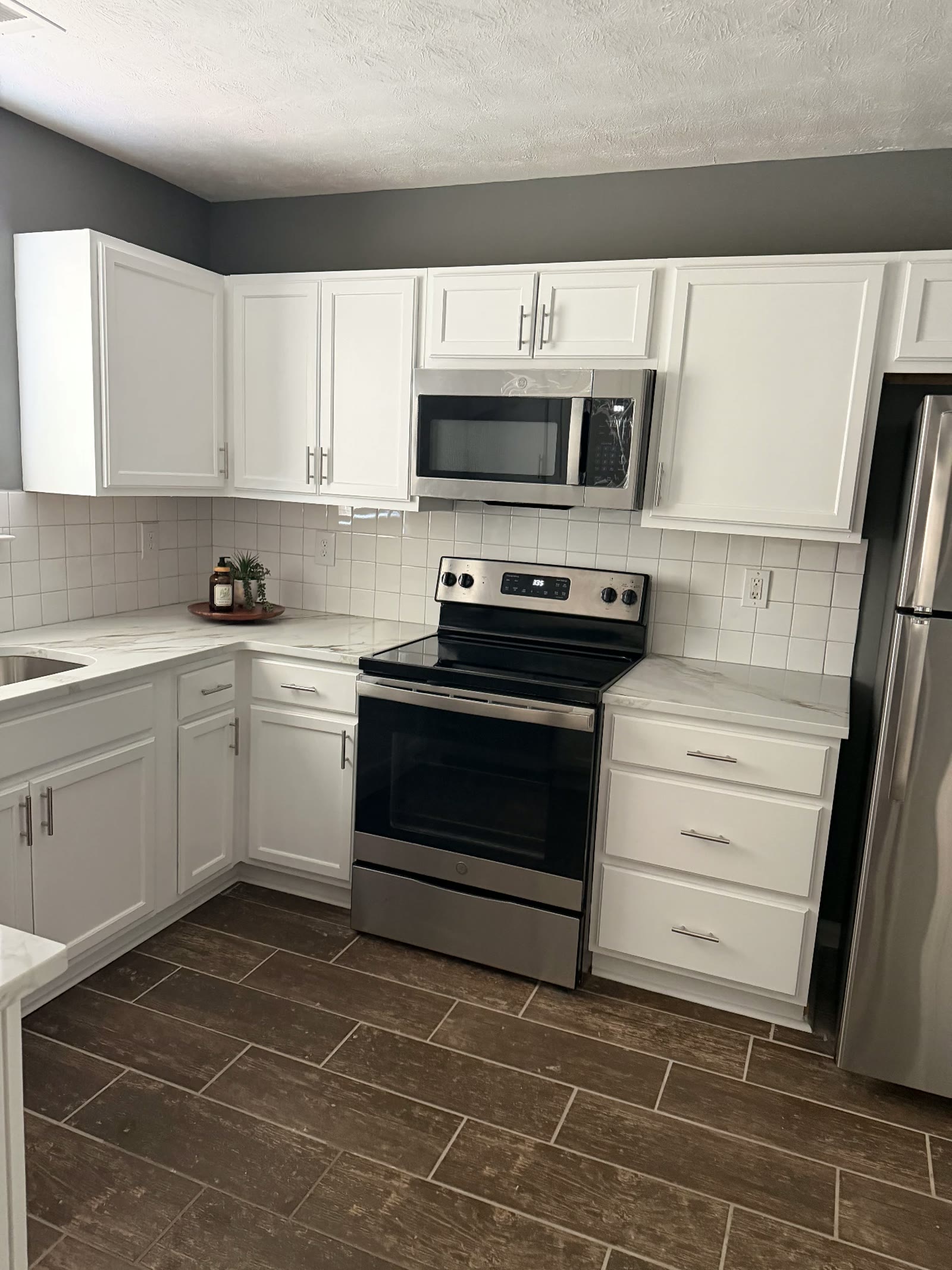 Kitchen with range, microwave, and refrigerator