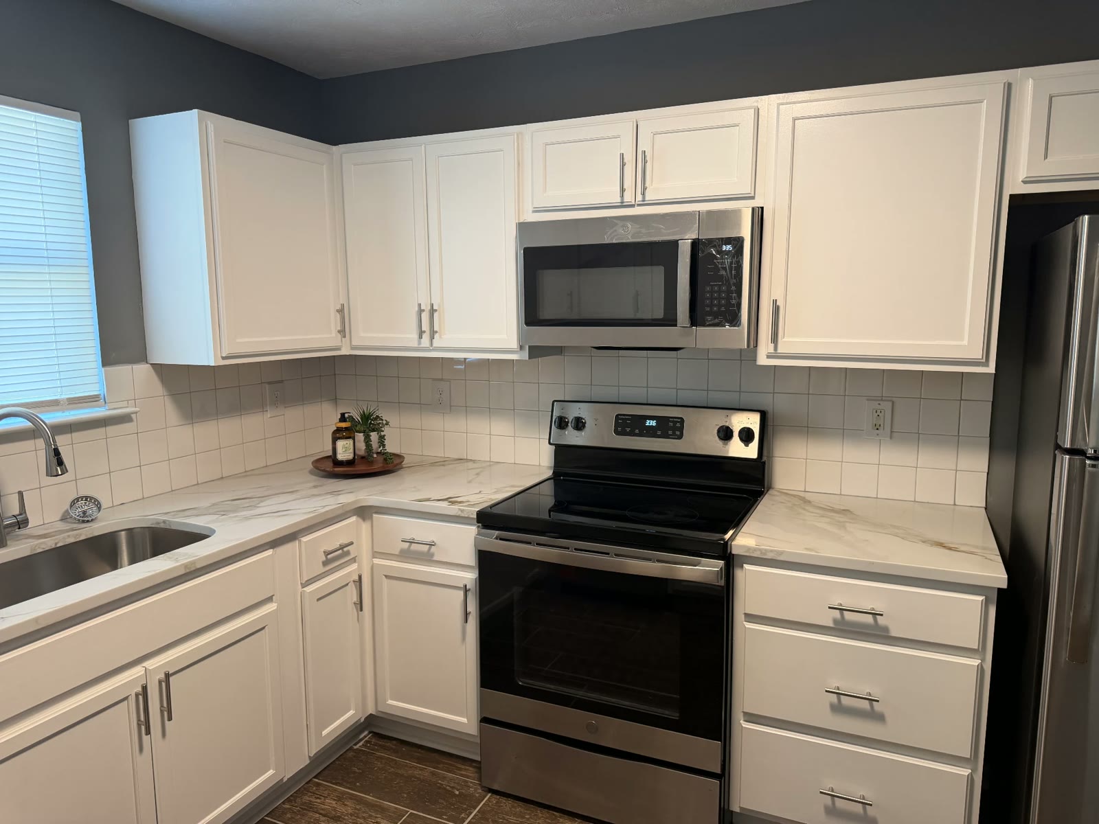 Updated kitchen with white cabinets and stainless appliances
